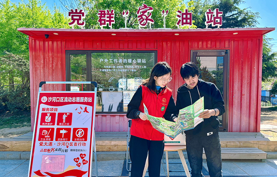 (頭題配圖)志愿者在大連沙河口區(qū)流動志愿服務(wù)站服務(wù)游客